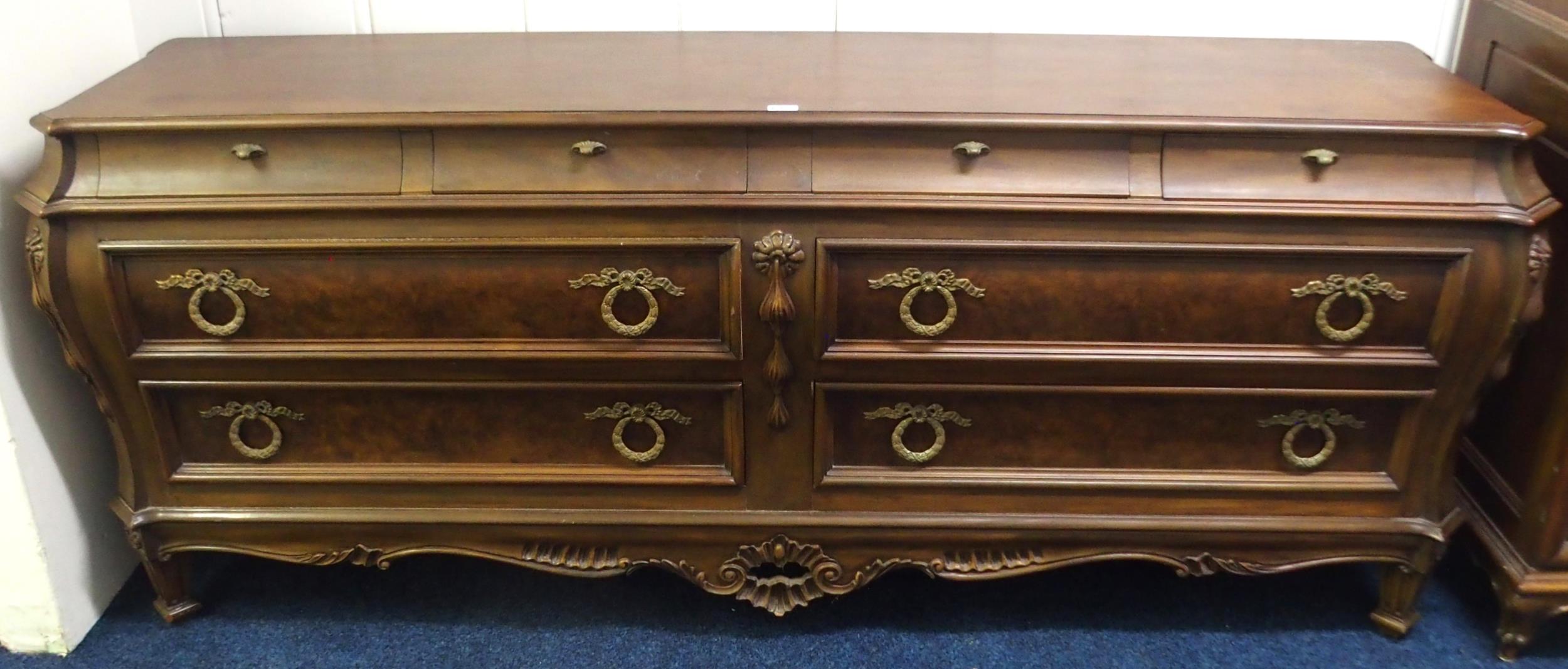 A modern Karges of Grand Rapid Michigan reproduction Bombe form bank of eight drawers with four