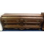 A modern Karges of Grand Rapid Michigan reproduction Bombe form bank of eight drawers with four