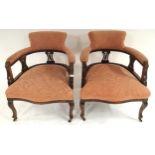 A pair of late Victorian mahogany framed tub chairs with pink floral upholstery (2) Condition