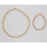 A 9ct gold necklet and bracelet with twist pattern, stamped FLOWERS. Length of the necklet 41.5cm,