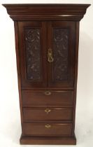 An early 20th century mahogany apprentice style cabinet with moulded cornice over pair of scrolled