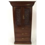 An early 20th century mahogany apprentice style cabinet with moulded cornice over pair of scrolled