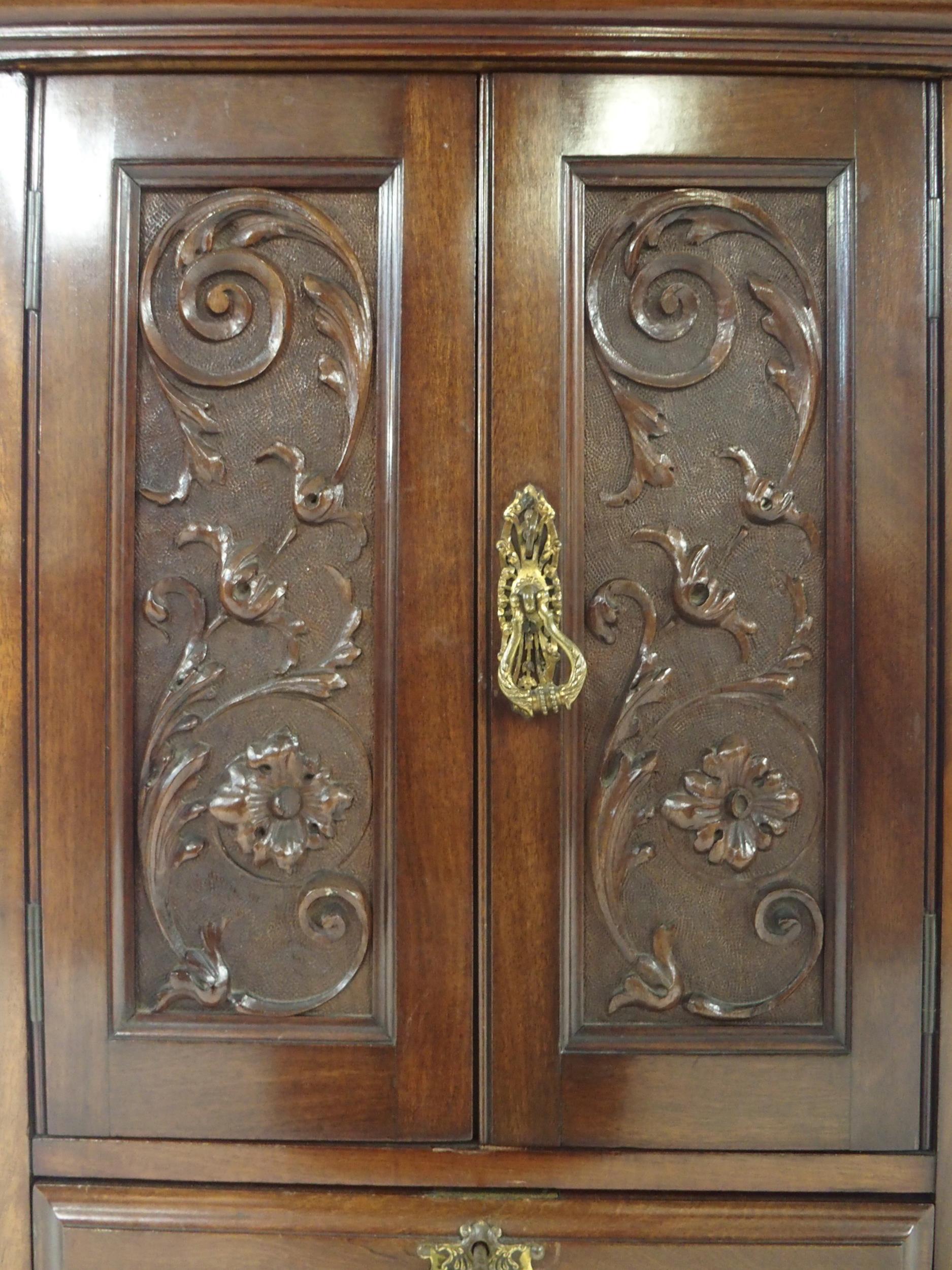 An early 20th century mahogany apprentice style cabinet with moulded cornice over pair of scrolled - Image 2 of 4