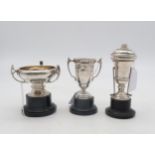 Three silver presentation trophy cups, one by Adie Brothers Ltd, another golfing themed example,