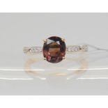 An 18ct gold GemsTV colour change garnet and diamond ring, designed by Thomas Rae, finger size N1/2,