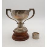An Edwardian silver twin handled trophy cup, with a turned wooden base, by William Neale Ltd,