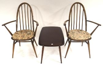 A pair of mid 20th century elm and beech Ercol rail back dining carvers and a elm and beech Ercol