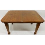 A Victorian oak arts & crafts extending dining table on square tapering supports with one additional