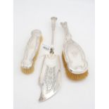 An Edwardian two piece silver vanity set, comprising a hair and clothes brush, with Art Nouveau