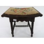 A Victorian mahogany framed stool with tapestry upholstered seat on turned bobbin stretchers and