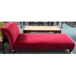 A Victorian red velour upholstered day bed/chaise lounge on turned walnut supports terminating in