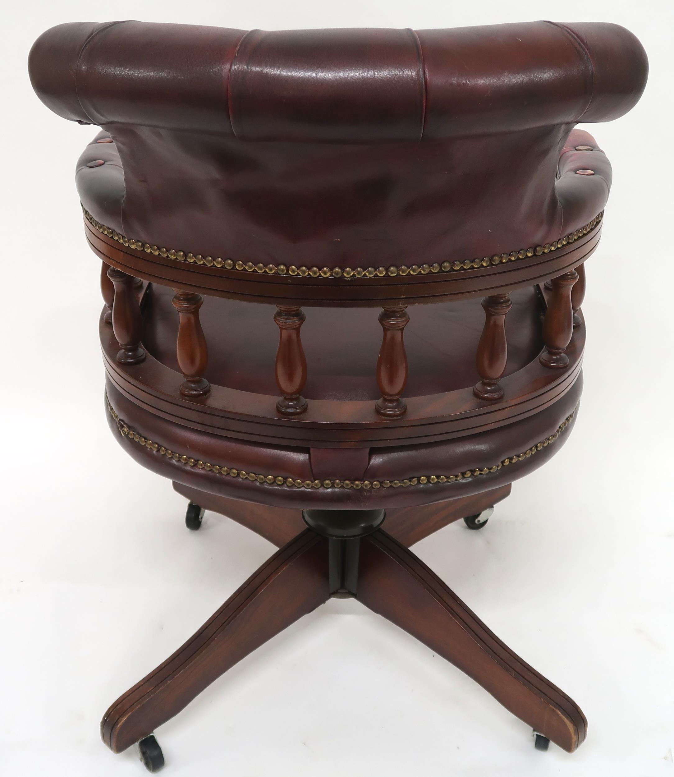 A 20th century oxblood leather upholstered revolving "captain's" desk chair, 85cm high x 63cm wide x - Image 7 of 7