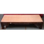 A 19th century Oriental hardwood low coffee table with extensively carved fretwork friezes on shaped
