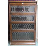 An early 20th century oak four tier sectional bookcase with leaded glass doors, 146cm high x 87cm