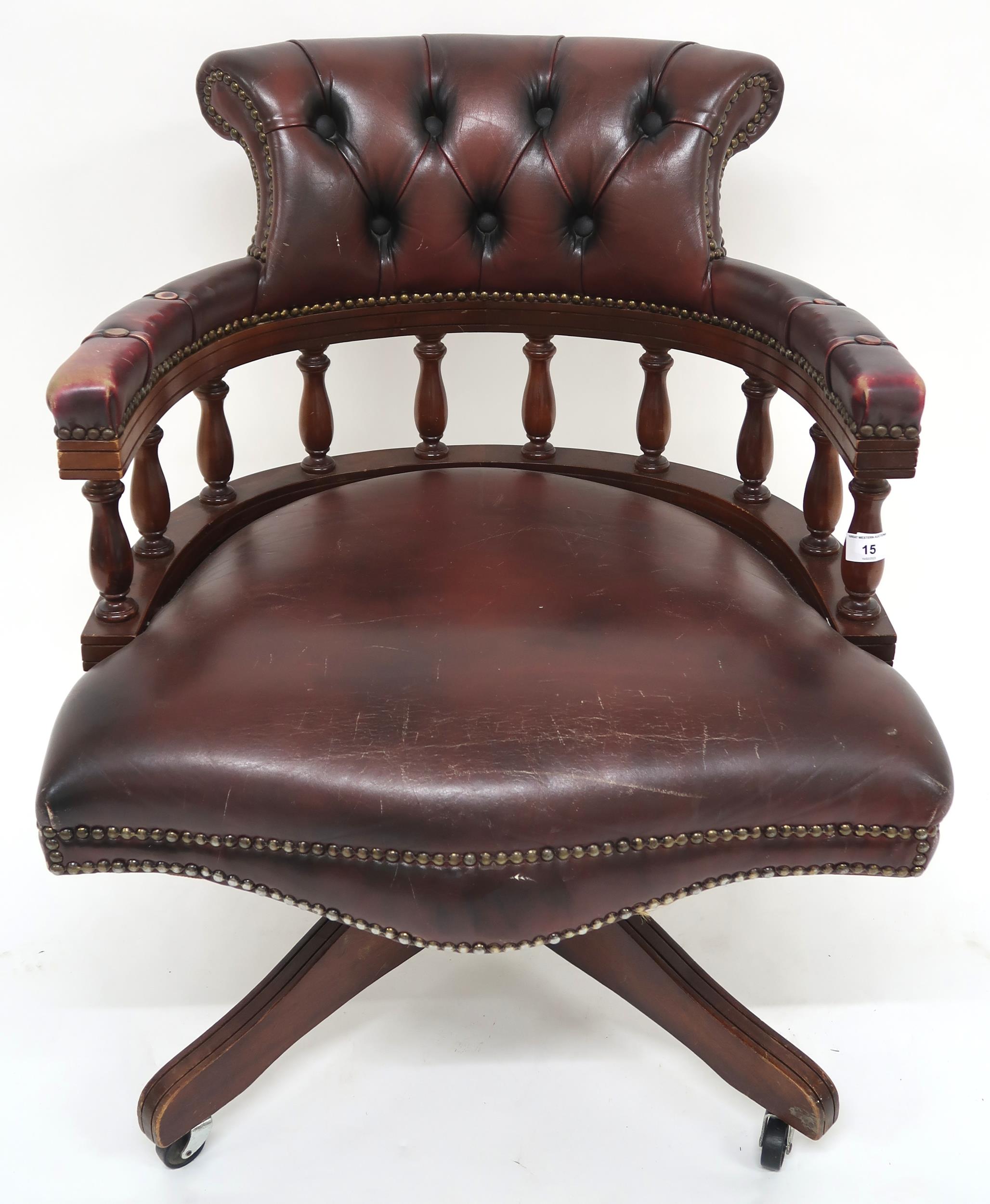 A 20th century oxblood leather upholstered revolving "captain's" desk chair, 85cm high x 63cm wide x