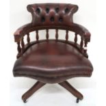 A 20th century oxblood leather upholstered revolving "captain's" desk chair, 85cm high x 63cm wide x