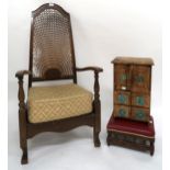 An early 20th century mahogany cane backed armchair, counter top cabinet in the apprentice style and