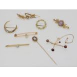 *PLEASE NOTE: The pearl crescent and floral brooch are no longer in this lot* A 15ct gold peridot