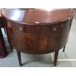 An early 20th century mahogany demi lune sideboard with single central drawer over pair of cabinet