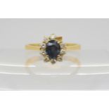 An 18ct gold sapphire and diamond ring, set with estimated approx 0.13cts (one diamond missing)