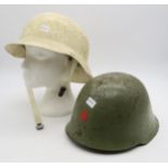 A Yugoslavian M59 steel helmet and a West German fibreglass Civil Defence helmet (2) Condition