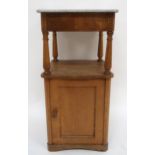 A late 19th/early 20th century marble topped bedside cabinet with single drawer over turned uprights