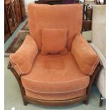 A 20th century elm and beech framed Ercol golden dawn armchair with terracotta upholstery, 96cm high