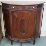 A 20th century mahogany Maple & Co demi lune cabinet with single short drawer over single door on
