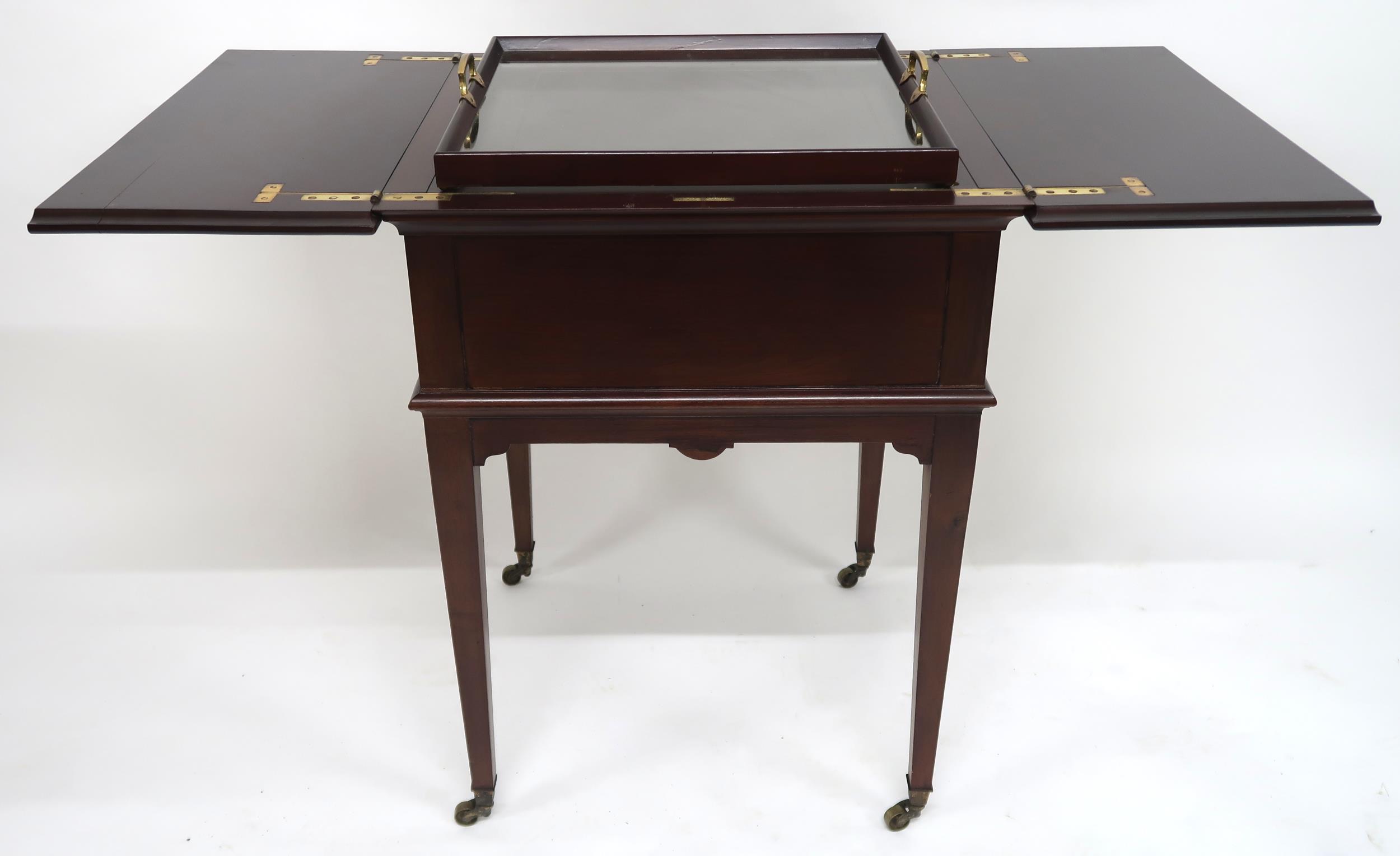 A 20th century mahogany drinks/tea table with split hinged top concealing rising glass and