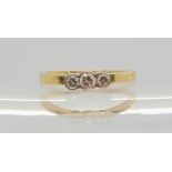 An 18ct gold three stone diamond ring, set with estimated approx 0.20cts of brilliant cut