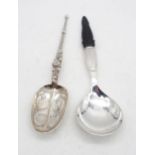 An early 20th century Danish silver spoon, with a hammered pear shaped bowl, with a carved ebony