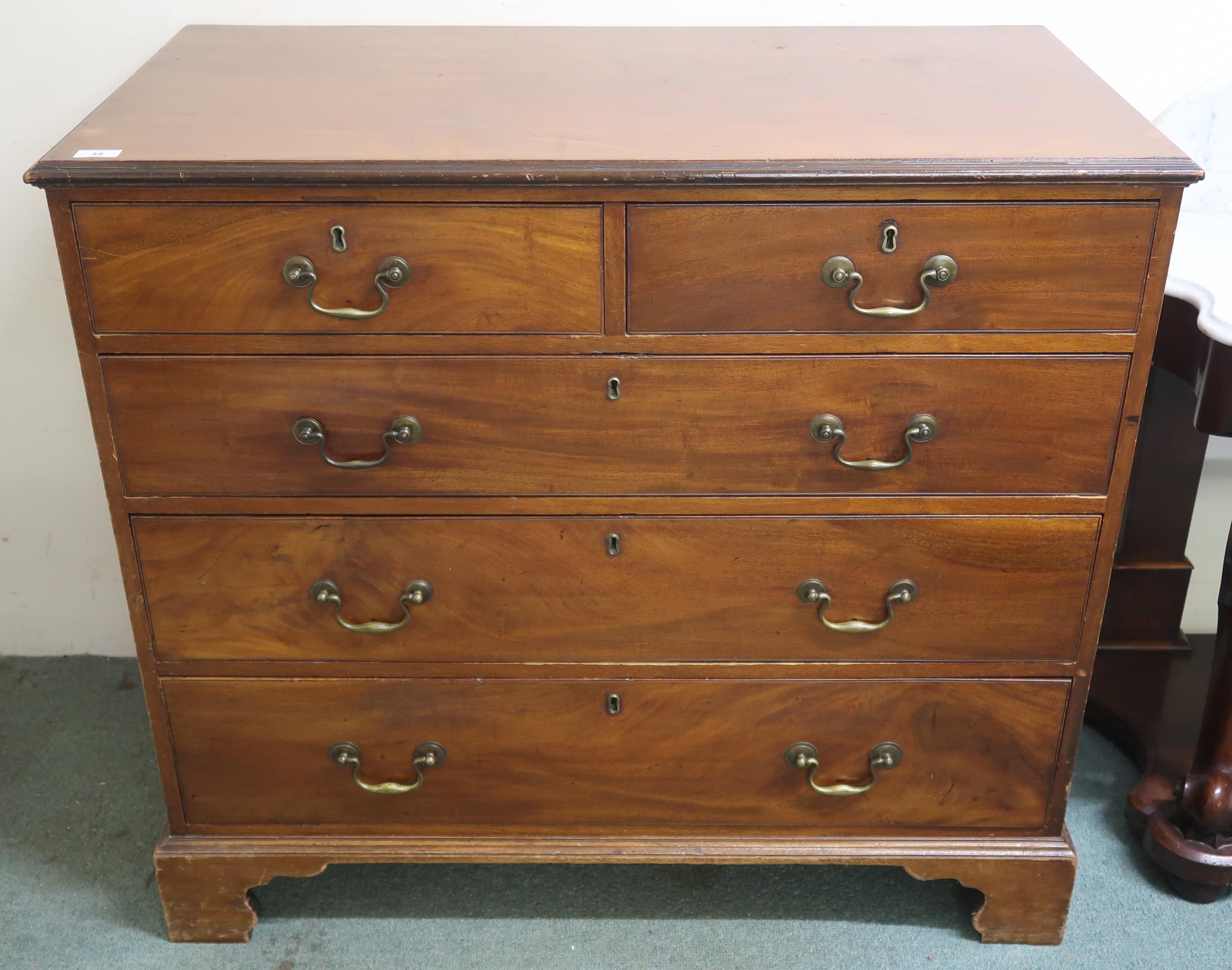 A 19th century mahogany two over three chest of drawers with brass drawer pulls on bracket feet,