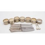 A collection of silver including a set of four napkin rings, with engraved scrolling foliate