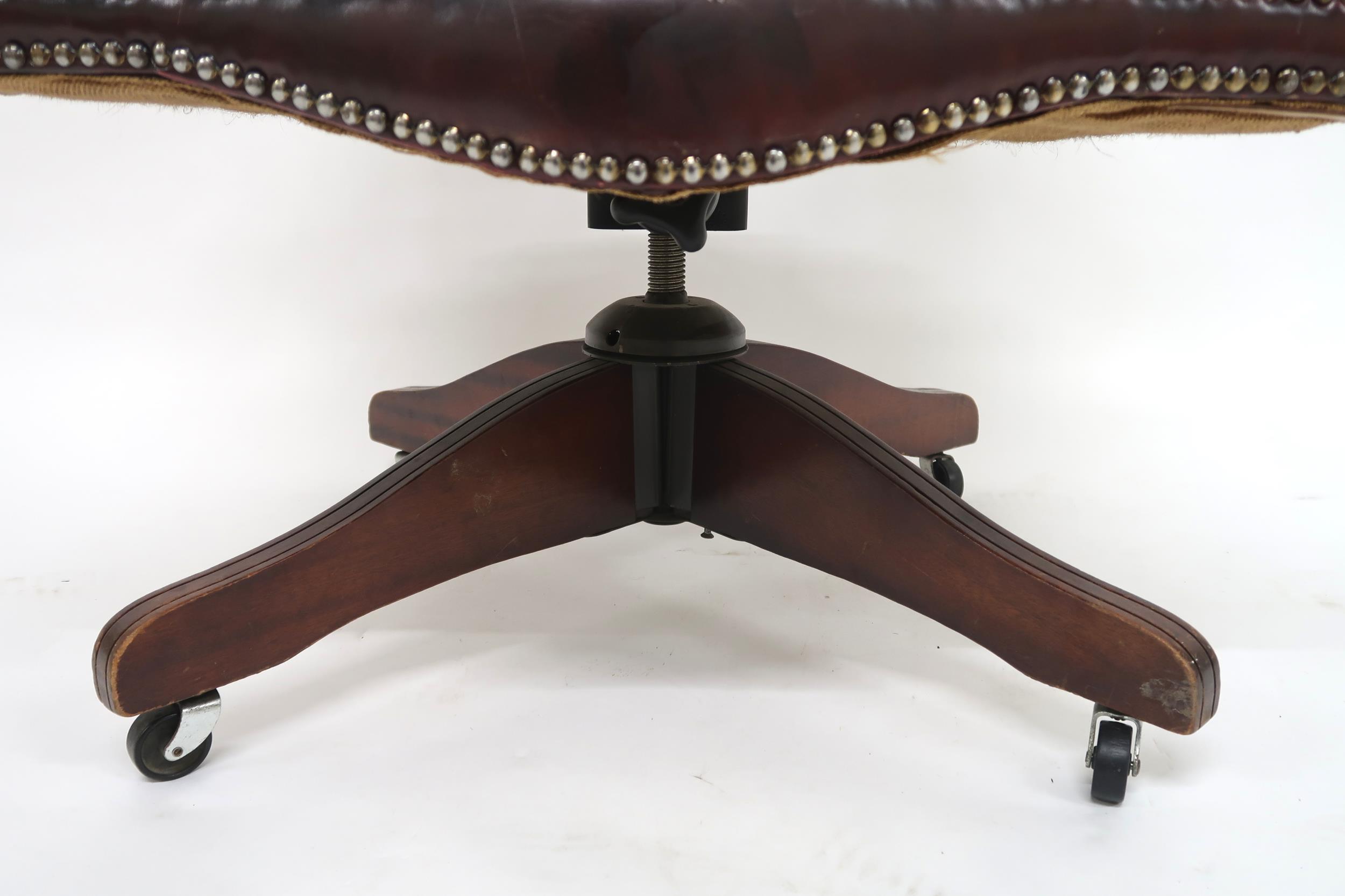 A 20th century oxblood leather upholstered revolving "captain's" desk chair, 85cm high x 63cm wide x - Image 4 of 7