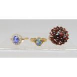 A 9ct gold garnet cluster ring, size L, and a 9ct gold opal triplet ring, size O1/2, and a blue