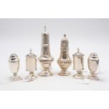 A collection of silver casters, including a George III silver sugar caster, of baluster form, with