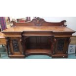 A Victorian mahogany inverted breakfront sideboard with central open recess flanked by cabinet doors