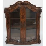 A 19th century burr walnut veneered display with shaped carved cornice over pair of glazed doors