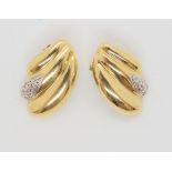 A pair of 14k gold clip on earrings with cz accents, weight 5.9gms Condition Report:Available upon