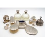 A collection of silver and white metal including a white metal vanity set, comprising a hand mirror,