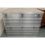 A pair of 20th century aluminium flight cases with hinged tops, 42cm high x 119cm wide x 79cm