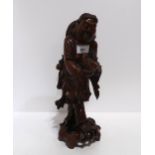 A carved wooden Chinese figure of a man holding a fish Condition Report:Available upon request