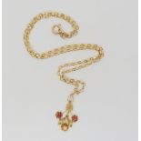 A 10k gold Edwardian pendant set with red gems a pearl and a faux pearl, length 3.4cm, length of 9ct