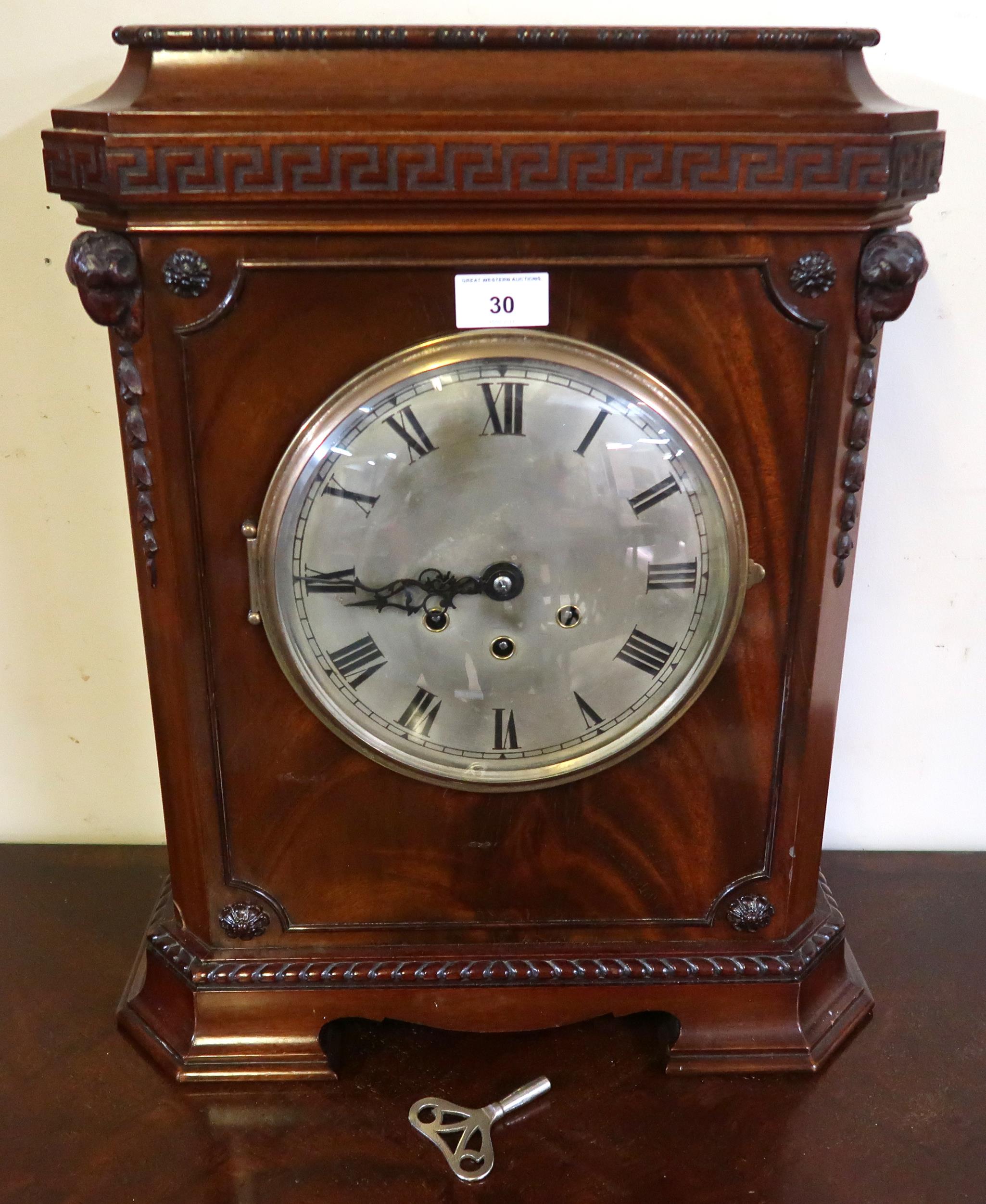 A 20th century mahogany cased mantle clock with Grecian key design over silvered dial bearing