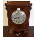 A 20th century mahogany cased mantle clock with Grecian key design over silvered dial bearing