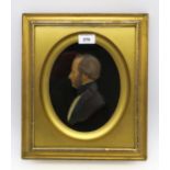 A large Victorian wax portrait of a gentleman in profile, in gilt frame, measuring approx. 36cm x