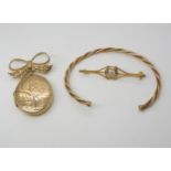 A 9ct gold locket brooch with bow mount, a 9ct gold bangle and a brooch, weight together 15gms