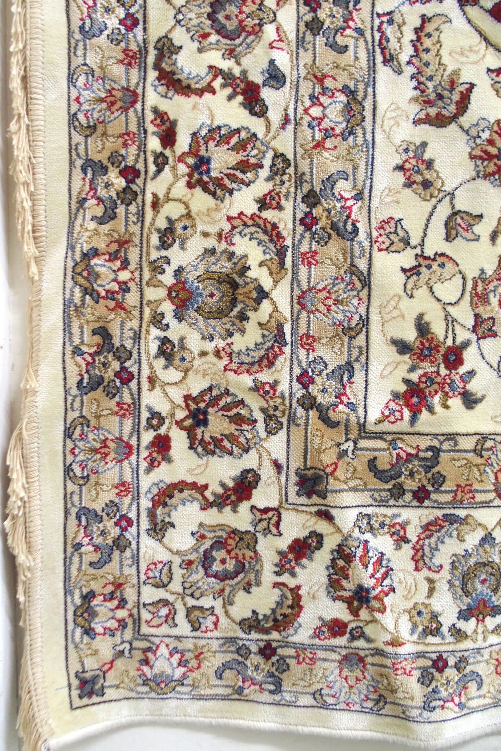 A cream ground machine made Kashmiri rug with all-over floral design and flower head borders, - Image 3 of 6