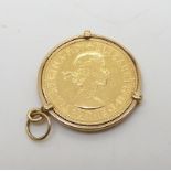 A 1958 full gold sovereign in yellow metal coin mount, weight 9.3gms Condition Report:Available upon