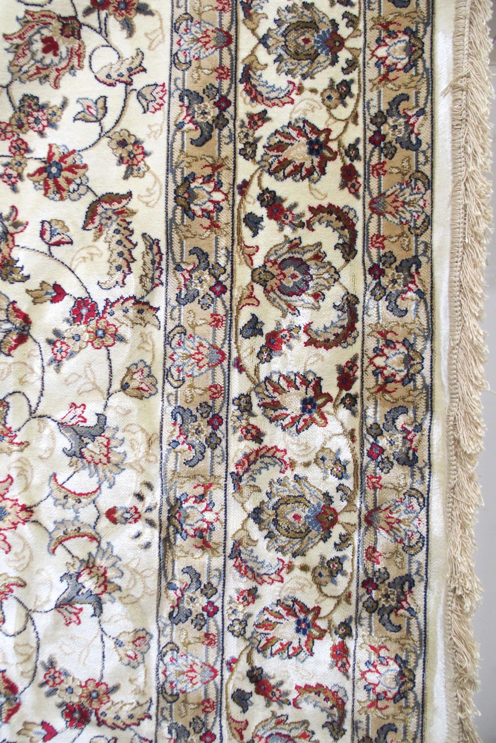 A cream ground machine made Kashmiri rug with all-over floral design and flower head borders, - Image 4 of 6